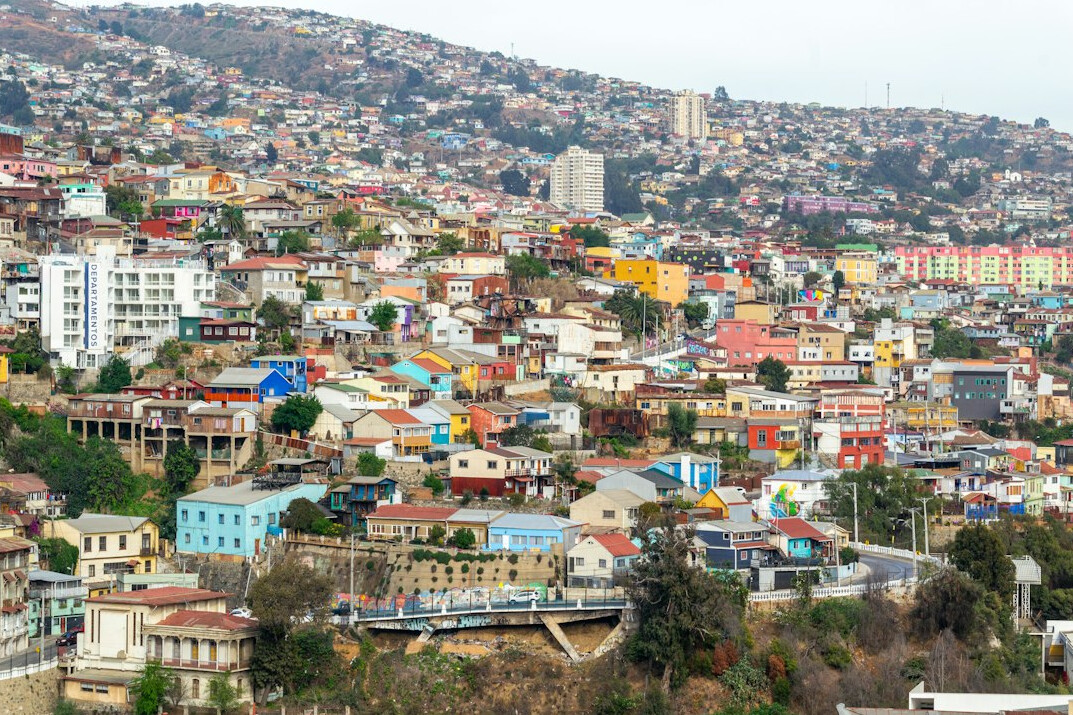 Colorful hillside street in Valparaíso, Chile with people walking