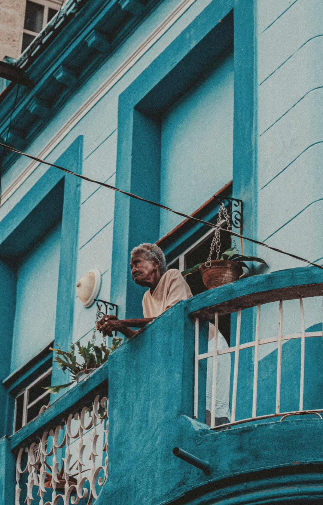 Elderly Chilean woman sitting on a balcony in the city